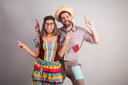 Photo for Brazilian couple dressed in festa junina clothes, feast of So Joo dancing. - Royalty Free Image