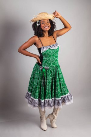 Photo for Vertical portrait, black Brazilian woman in festa junina clothes. Saint John's festival. - Royalty Free Image