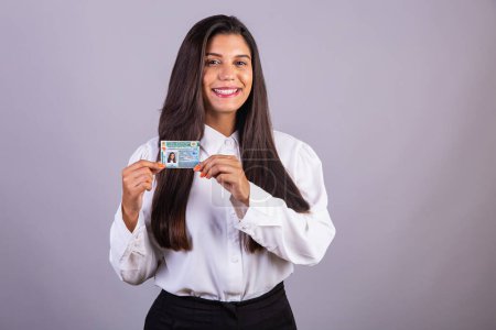 Brazilian businesswoman with driver's license. Translation in English (national driver's license)