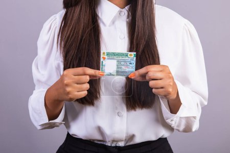 Photo for Brazilian woman holding driver's license. Translation in English (national driver's license) - Royalty Free Image