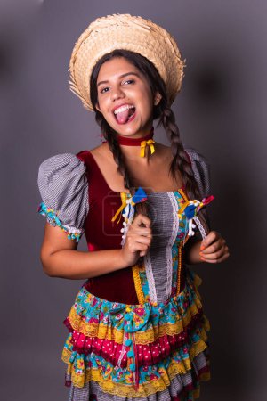 Photo for Brazilian woman, clothes from festa junina, arraial, festa de so joo. Vertical portrait - Royalty Free Image