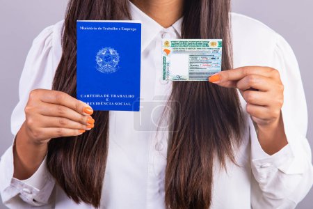 Photo for Brazilian woman holding work permits and driver's license. Translation in English (national driver's license) (Employment Card and Social Security) - Royalty Free Image