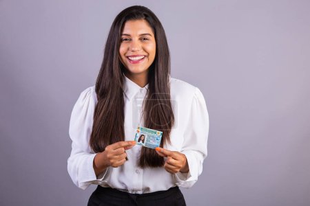Photo for Brazilian businesswoman with driver's license. Translation in English (national driver's license) - Royalty Free Image