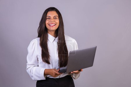 Photo for Brazilian woman holding notebook, laptop computer. - Royalty Free Image