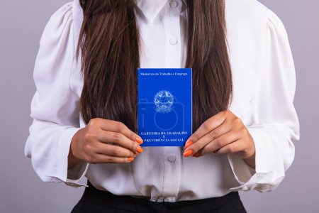 Téléchargez les photos : Femme d'affaires brésilienne, avec carte de travail. traduction en anglais (carte d'emploi et sécurité sociale) - en image libre de droit