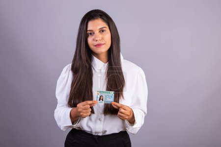 Photo for Brazilian businesswoman with driver's license. Translation in English (national driver's license) - Royalty Free Image
