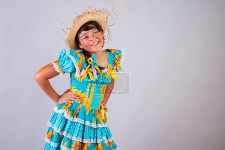 Photo for Child, Brazilian girl, in festa junina clothes, hands on hips. - Royalty Free Image