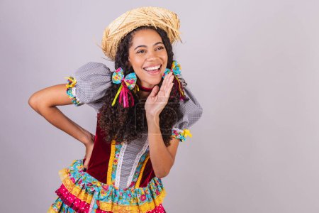 Photo for Black, Brazilian woman, wearing June party clothes, fraternization in the name of So Joo, Arraial. Screaming promotion - Royalty Free Image