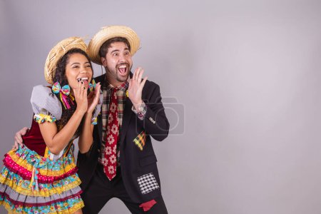 Brazilian couple, wearing June party clothes, fraternization in the name of So Joo, Arraial. shouting and announcing