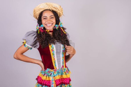 Photo for Black, Brazilian woman, wearing June party clothes, fraternization in the name of So Joo, Arraial. hands on waist - Royalty Free Image