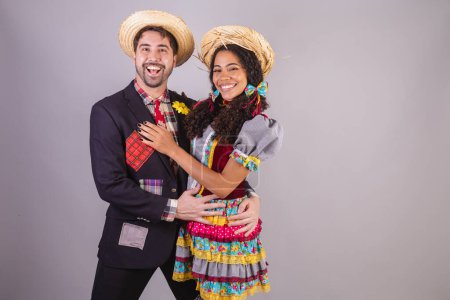 Photo for Brazilian couple, wearing June party clothes, fraternization in the name of So Joo, Arraial. - Royalty Free Image