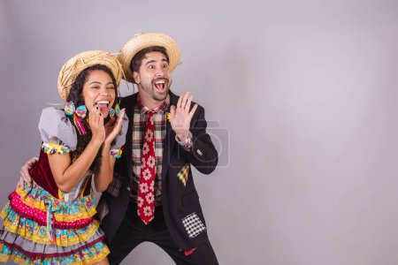 Photo for Brazilian couple, wearing June party clothes, fraternization in the name of So Joo, Arraial. shouting and announcing - Royalty Free Image