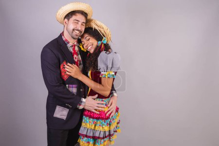Photo for Couple, brazilian, wearing clothes from festa junina, fraternization in the name of So Joo, Arraial. embraced - Royalty Free Image