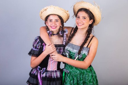 Photo for Girls, sisters, friends, Brazilian, with June party clothes, arraial, So Joo party. Horizontal portrait. - Royalty Free Image