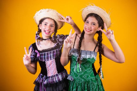 Girls, sisters, friends, Brazilian, with June party clothes, arraial, So Joo party. Horizontal portrait.   