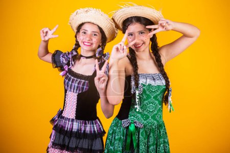 Photo for Girls, sisters, friends, Brazilian, with June party clothes, arraial, So Joo party. Horizontal portrait. - Royalty Free Image