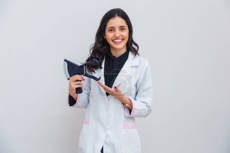Brazilian, Caucasian woman wearing lab coat, holding adipometer for body measurement, slimming.
