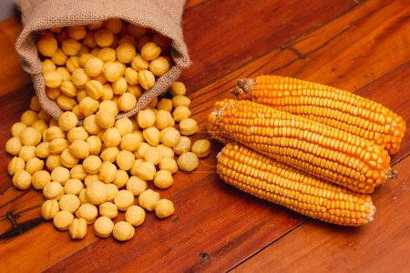 Photo for Corn, round corn snacks, in a linen bag, on a wooden background - Royalty Free Image