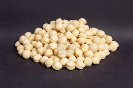 Photo for Wheat, heap of round wheat snacks, black background - Royalty Free Image