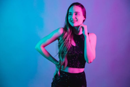 Photo for Model on blue and pink neon background posing for photo. smiling with hand on chin. - Royalty Free Image