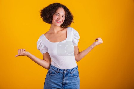 Photo for Caucasian model, in white shirt and blue jeans, celebrating. - Royalty Free Image