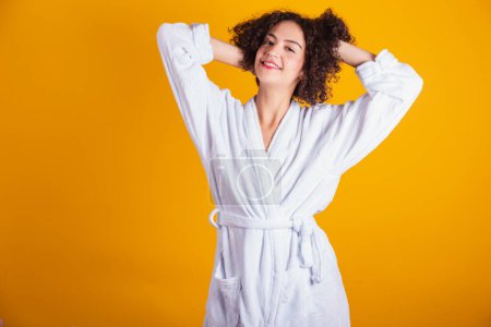 Photo for Caucasian model in white bathrobe. hands in hair. - Royalty Free Image