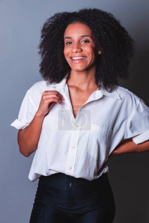 Foto de Retrato de medio cuerpo, mujer brasileña negra, camisa blanca sonriendo. - Imagen libre de derechos