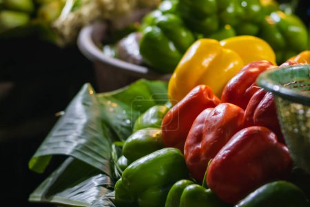 Bell pepper of yellow, red and green colours kept in vegetable market for selling.