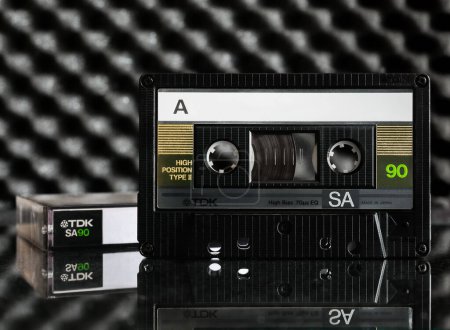 Téléchargez les photos : Cassette audio TDK SA90 (Super Avilyn Technology) à partir de 1986 sur une table miroir - en image libre de droit