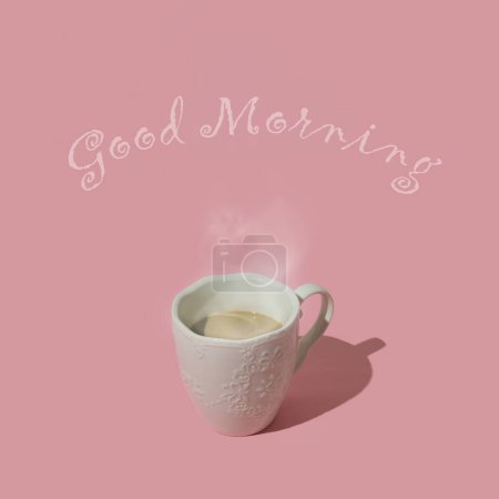 Foto de Composición elegante hecha de café humeante sobre fondo rosa pastel con mensaje de "Buenos días". Mínimo concepto de café creativo. Idea de fondo de moda. Estética café. - Imagen libre de derechos