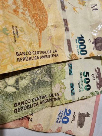 Flat lay of worn out Argentine bills