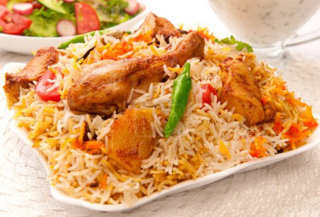 Photo for Chicken biyani served with chicken leg piece and green chilies. - Royalty Free Image
