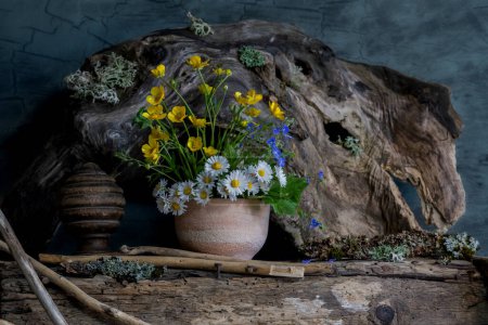 Photo for A bouquet of wild flowers in a clay pot, in an ethnic style - Royalty Free Image