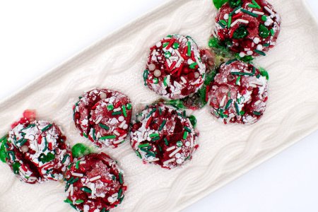 Photo for Top down photo of red, white, and green christmas crinkle cookies with sprinkles and powdered sugar on a serving plate - Royalty Free Image