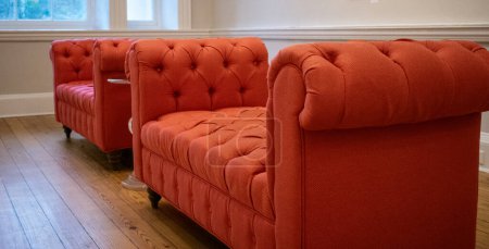 Téléchargez les photos : Canapés-lits tuftés orange dans un cadre de bureau de réception - en image libre de droit