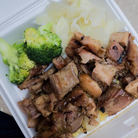 Photo for Chinese takeout teriyaki chicken, fried rice, and broccoli in a styrofoam to go container - Royalty Free Image