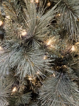 Photo for Close up photo of a sparkly snowflake ornament on a silver Christmas tree - Royalty Free Image