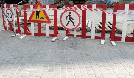 Photo for Fence under construction. Blocking the street. Prohibition signs on the fence. - Royalty Free Image