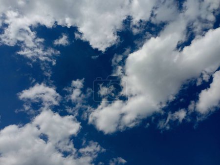 Blue sky with small white clouds. Nature and its backgrounds and textures.