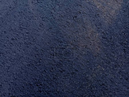 Texture of black fresh tarry asphalt. Road theme and textures on the theme of transport and road surface.