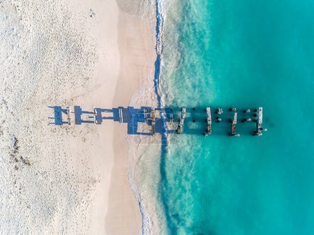 Photo for Aerial view of the beautiful old Jurien Bay Jetty in tropical turquoise ocean sea waters with shallow waves. Vibrant bright sunny day in summer wallpaper. Seascape background. Coastal wallpaper. - Royalty Free Image