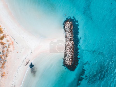 Aerial view of beautiful tropical turquoise ocean sea waters with shallow waves on the breakwater. Vibrant bright sunny day in summer wallpaper. Seascape background. Coastal wallpaper.