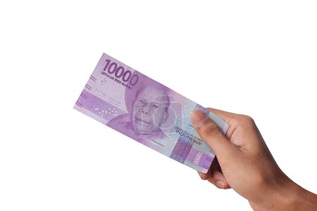 Photo for Hand holding ten thousand rupiah note isolated on white background - Royalty Free Image