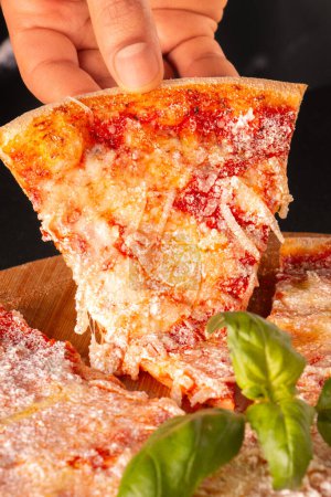 Amazing italian pizza quattro formaggi, close up with hand. High quality photo