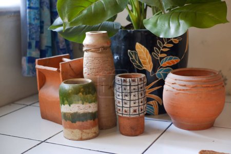 Photo for A collection of pottery and clay products, on display or in a collection in a corner of the house - Royalty Free Image