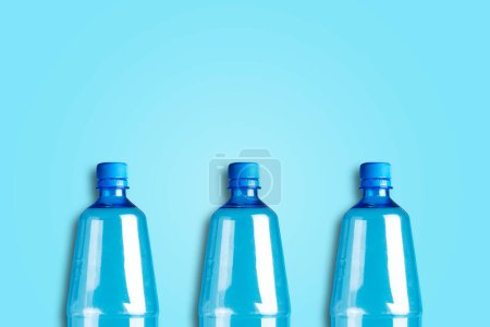 Plastic bottles on a blue background. Copy space. Products, packaging, storage recycle