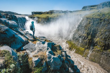 Photo for Woman on the cliff of Dettifoss most powerful waterfall in Europe, Iceland. - Royalty Free Image