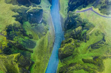Téléchargez les photos : Vue aérienne de la célèbre et unique vallée de Fjadrargljufur en Islande par un jour de pluie en Islande. falaises moussues et rivière de montagne. Destination touristique de voyage. - en image libre de droit