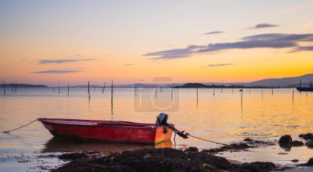 sunset view of a fishing boat in the sea