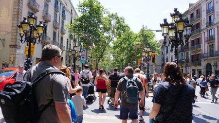 Photo for Barcelona, Spain - May 23 2023: La Rambla busy street photo with many walking people. La Rambla is the most popular pedestrian street in Barcelona city. - Royalty Free Image